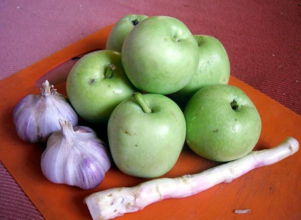 preparing a snack with horseradish and apple 