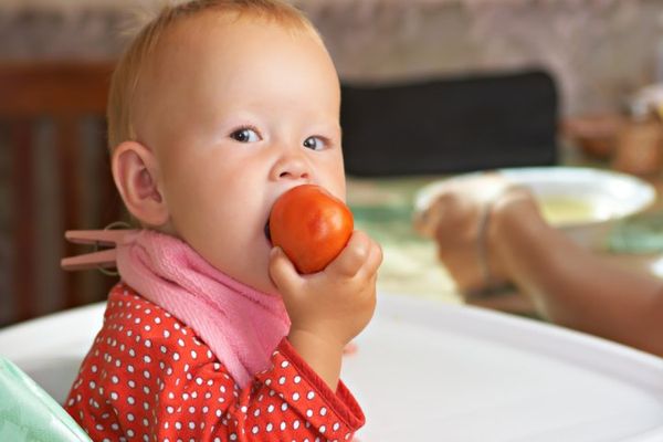 child eats tomato